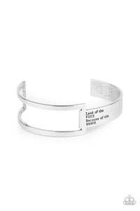 An airy rectangular frame attaches to a flat silver bar that curves around the wrist and is stamped in the phrase, “Land of the free because of the brave,” creating a patriotic inspired cuff. Sold as one individual.