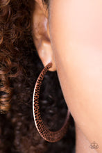 Load image into Gallery viewer, Delicately hammered in shimmery textures, a glistening copper hoop curls around the ear for a fierce fashion. Earring attaches to a standard post fitting. Hoop measures 2&quot; in diameter. Sold as one pair of hoop earrings.
