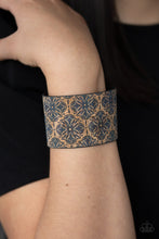 Load image into Gallery viewer, Painted in a regal blue floral pattern, a thick cork-like leather band wraps around the wrist for a statement-making look. Features an adjustable snap closure.  Sold as one individual bracelet.
