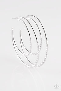 Featuring diamond-cut textures, two glistening silver bars curl into a bold hoop for a flawless finish. Earring attaches to a standard post fitting. Hoop measures 2 3/4” in diameter. Sold as one pair of hoop earrings.