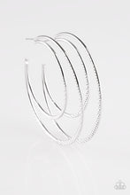 Load image into Gallery viewer, Featuring diamond-cut textures, two glistening silver bars curl into a bold hoop for a flawless finish. Earring attaches to a standard post fitting. Hoop measures 2 3/4” in diameter. Sold as one pair of hoop earrings.
