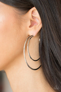 Featuring diamond-cut textures, two glistening silver bars curl into a bold hoop for a flawless finish. Earring attaches to a standard post fitting. Hoop measures 2 3/4” in diameter. Sold as one pair of hoop earrings.