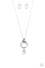 Load image into Gallery viewer, Trios of exaggerated silver rings link at the bottom of a lengthened silver chain, creating a dramatic industrial pendant. A lobster clasp hangs from the bottom of the design to allow a name badge or other item to be attached. Features an adjustable clasp closure.  Sold as one individual lanyard. Includes one pair of matching earrings.
