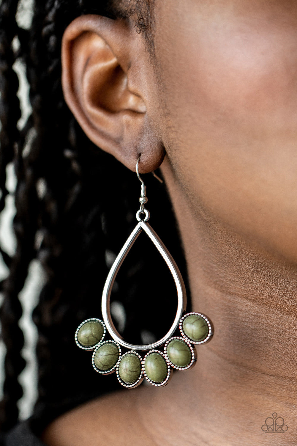 Featuring decorative silver fittings, earthy green stones fan out from the bottom of an airy silver teardrop frame for a seasonal flair. Earring attaches to a standard fishhook fitting. Sold as one pair of earrings.