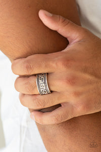 A thick silver band is studded and embossed in a tribal inspired pattern for an edgy look. Features a stretchy band for a flexible fit.  Sold as one individual ring.