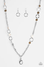Load image into Gallery viewer, Delicately hammered in shimmery textures, glistening gold discs and abstract silver hoops trickle along a bold silver chain for a fierce industrial look. A lobster clasp hangs from the bottom of the design to allow a name badge or other item to be attached. Features an adjustable clasp closure.  Sold as one individual lanyard. Includes one pair of matching earrings.

