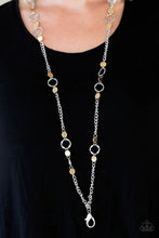 Load image into Gallery viewer, Delicately hammered in shimmery textures, glistening gold discs and abstract silver hoops trickle along a bold silver chain for a fierce industrial look. A lobster clasp hangs from the bottom of the design to allow a name badge or other item to be attached. Features an adjustable clasp closure.  Sold as one individual lanyard. Includes one pair of matching earrings.
