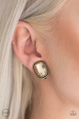Faceted topaz gems are pressed into textured brass frames for a refined look. Earring attaches to a standard clip-on fitting.  Sold as one pair of clip-on earrings.
