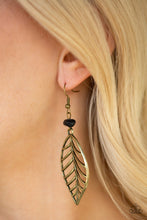 Load image into Gallery viewer, An airy brass leaf swings from the bottom of an earthy black pebble, creating a seasonal lure. Earring attaches to a standard fishhook fitting.  Sold as one pair of earrings.
