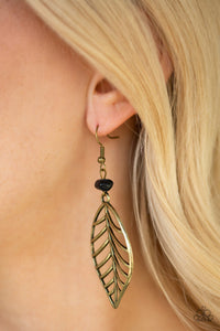 An airy brass leaf swings from the bottom of an earthy black pebble, creating a seasonal lure. Earring attaches to a standard fishhook fitting.  Sold as one pair of earrings.