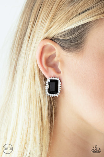 Featuring a regal emerald style cut, a dramatic black gem is pressed into the center of a silver frame radiating with glassy white rhinestones for a show-stopping look. Earring attaches to a standard clip-on fitting.  Sold as one pair of clip-on earrings.