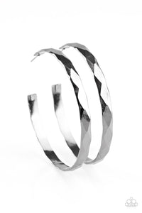 Featuring edgy diamond-cut texture, a glistening gunmetal hoop curls around the ear in a bold industrial fashion. Earring attaches to a standard post fitting. Hoop measures 2 1/4” in diameter. Sold as one pair of hoop earrings.