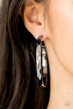 Load image into Gallery viewer, Featuring edgy diamond-cut texture, a glistening gunmetal hoop curls around the ear in a bold industrial fashion. Earring attaches to a standard post fitting. Hoop measures 2 1/4” in diameter.  Sold as one pair of hoop earrings.

