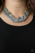 Load image into Gallery viewer, Strands of gunmetal seed beads create an indigenous braid below the collar. The gunmetal seed beads gradually morph into metallic silver beads at the center for a chic contrasting look. Features an adjustable clasp closure. Sold as one individual necklace. Includes one pair of matching earrings.
