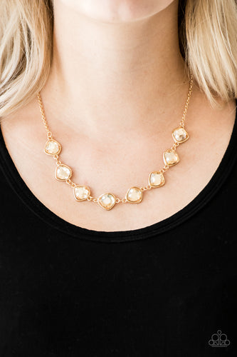 Featuring shimmery gold frames, imperfect golden gems link below the collar for a glamorous vintage inspired look. Features an adjustable clasp closure. Includes one pair of matching earrings.