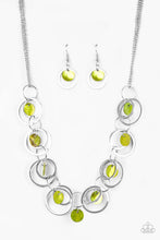 Load image into Gallery viewer, Bits of iridescent green shell swing from the bottoms of mismatched silver hoops below the collar for a summery look. Features an adjustable clasp closure.  Includes one pair of matching earrings.
