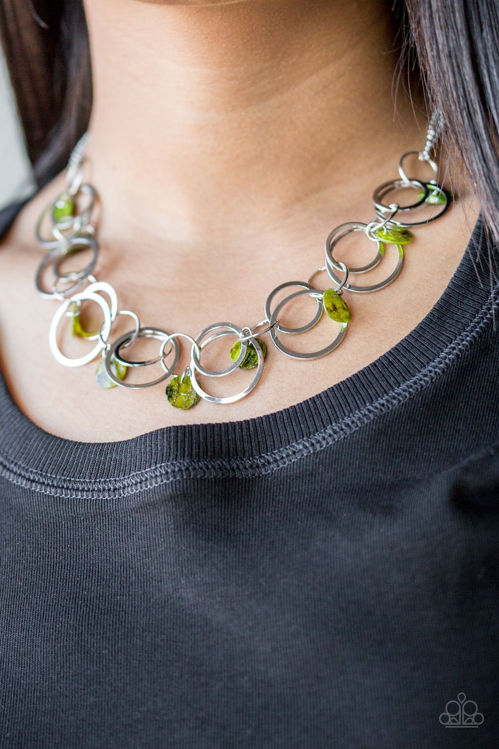 Bits of iridescent green shell swing from the bottoms of mismatched silver hoops below the collar for a summery look. Features an adjustable clasp closure.  Includes one pair of matching earrings.