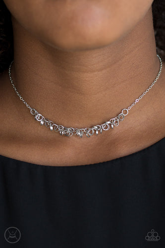 Dainty silver rings swing from a dainty silver chain, creating a flirtatious fringe. Features an adjustable clasp closure.  Sold as one individual choker necklace. Includes one pair of matching earrings.