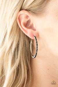 Encrusted in glassy black rhinestones, a textured silver hoop curls around the ear for a refined look. Earring attaches to a standard post fitting. Hoop measures 1 3/4" in diameter.  Sold as one pair of hoop earrings.
