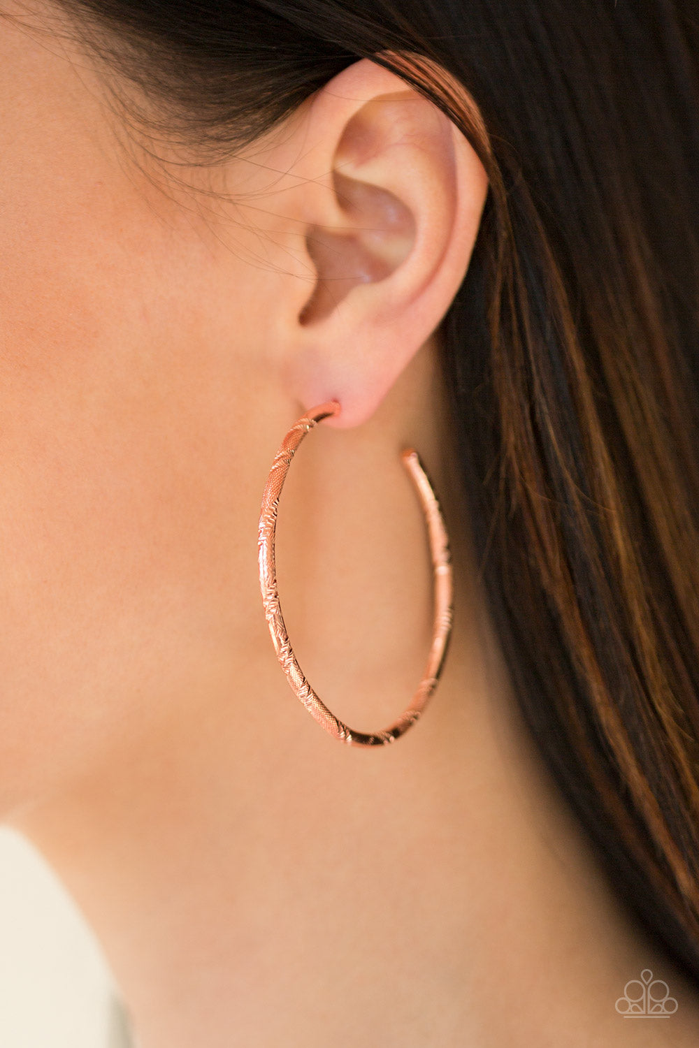 Etched in ribbons of diamond-cut shimmer, a shiny copper hoop curls around the ear for a classic look. Earring attaches to a standard post fitting. Hoop measures 2 1/4