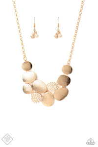 A collection of gold asymmetrical oval discs connect into a clustered pendant below the collar for a refined flair. Etched linear textures or white rhinestones adorn each disc, offering a gorgeous collision of texture, sheen, and sparkle. Features an adjustable clasp closure. Includes one pair of matching earrings.