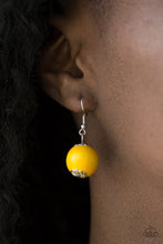 Load image into Gallery viewer, Yellow wooden bead dangling from a silver fish hook earring.
