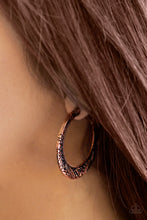 Load image into Gallery viewer, Stamped in tribal inspired patterns, a flattened copper bar curls around the ear for a seasonal look. Earring attaches to a standard post fitting. Hoop measures 1 1/2&quot; in diameter.  Sold as one pair of hoop earrings.
