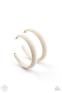 Earthy white twine-like cording is wrapped around a thick hoop, creating a colorful rustic display. Earring attaches to a standard post fitting. Hoop measures approximately 2 1/4" in diameter.  Sold as one pair of hoop earrings.