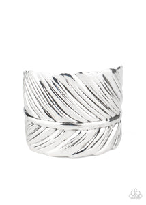 Embossed in life-like texture, an antiqued silver feather delicately curls around the wrist, creating a whimsical cuff.  Sold as one individual bracelet.