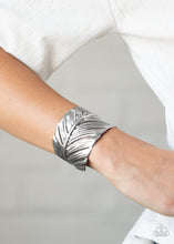 Load image into Gallery viewer, Embossed in life-like texture, an antiqued silver feather delicately curls around the wrist, creating a whimsical cuff.  Sold as one individual bracelet.
