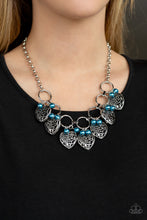 Load image into Gallery viewer, Infused with classic blue pearls, vintage locket-like heart frames swing from the bottoms of bold silver hoops, creating a flirtatious fringe below the collar. Features an adjustable clasp closure.  Sold as one individual necklace. Includes one pair of matching earrings.
