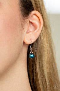 Small blue pearl hanging from a silver fish hook earring.