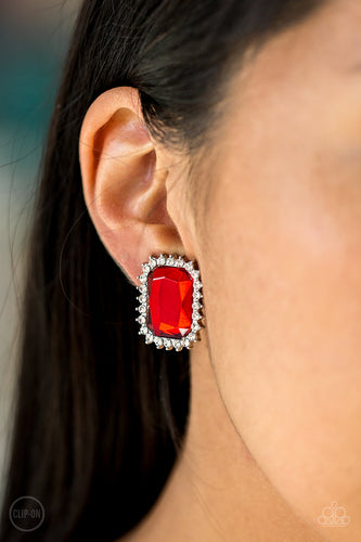 Featuring a regal emerald-style cut, a glittery red gem is pressed into a sleek silver frame radiating with dainty white rhinestones. Earring attaches to a standard clip-on fitting.  Sold as one pair of clip-on earrings.