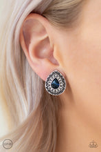 Load image into Gallery viewer, Encircled in glassy white rhinestones, a teardrop blue gem is pressed into the center of an ornate silver teardrop gem for a glamorous look. Earring attaches to a standard clip-on fitting.  Sold as one pair of clip-on earrings.

