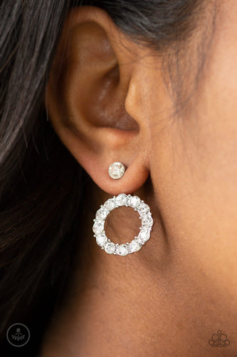 A solitaire white rhinestone attaches to a double-sided post, designed to fasten behind the ear. Encrusted in a ring of glassy white rhinestones, the glittery hoop peeks out beneath the ear for a glamorous look. Earring attaches to a standard post fitting.  Sold as one pair of double-sided post earrings.