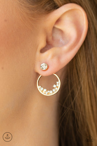 A solitaire white rhinestone attaches to a double-sided post, designed to fasten behind the ear. Encrusted in dainty white rhinestones, the circular double-side post peeks out beneath the ear for a bold look. Earring attaches to a standard post fitting.  Sold as one pair of double-sided post earrings.