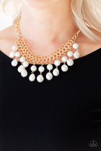 Load image into Gallery viewer, A collection of classic and imperfect white pearls dangle from a web of interlocking gold links below the collar, adding a modern twist to the timeless palette. Features an adjustable clasp closure. Sold as one individual necklace. Includes one pair of matching earrings.
