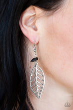 Load image into Gallery viewer, An airy silver leaf swings from the bottom of a shiny black pebble, creating a seasonal lure. Earring attaches to a standard fishhook fitting.  Sold as one pair of earrings.
