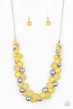 Load image into Gallery viewer, A bubbly collection of imperfect silver, opaque, and yellow beads are threaded along an invisible wire below the collar, creating a colorful cluster. Features an adjustable clasp closure.  Sold as one individual necklace. Includes one pair of matching earrings.
