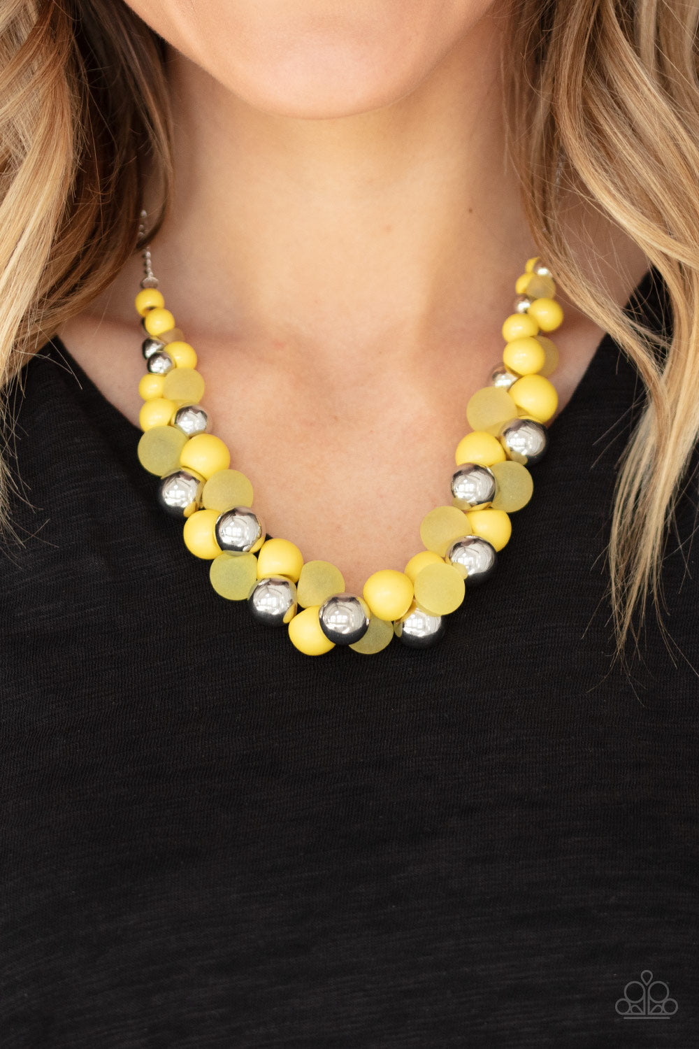 A bubbly collection of imperfect silver, opaque, and yellow beads are threaded along an invisible wire below the collar, creating a colorful cluster. Features an adjustable clasp closure.  Sold as one individual necklace. Includes one pair of matching earrings.