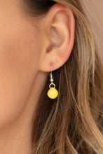 Load image into Gallery viewer, Yellow bead hanging from a silver fish hook earring.
