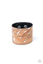 Load image into Gallery viewer, Pieces of cork have been plastered across the front of a shiny silver leather band, creating an earthy look around the wrist. Features an adjustable snap closure.  Sold as one individual bracelet.
