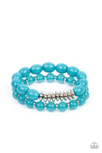 Load image into Gallery viewer, Infused with silver accents, rows of glassy and acrylic blue beads are threaded along stretchy bands around the wrist, resulting in a refreshing pop of color.
