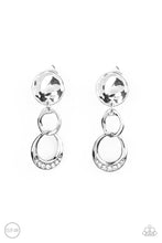 Load image into Gallery viewer, A hammered silver disc gives way to a textured asymmetrical silver link, and an imperfect silver ring dotted in glassy white rhinestones for a refined flair. Earring attaches to a standard clip-on fitting.  Sold as one pair of clip-on earrings.
