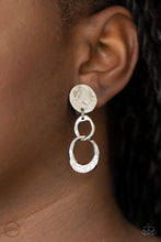 Load image into Gallery viewer, A hammered silver disc gives way to a textured asymmetrical silver link, and an imperfect silver ring dotted in glassy white rhinestones for a refined flair. Earring attaches to a standard clip-on fitting.  Sold as one pair of clip-on earrings.
