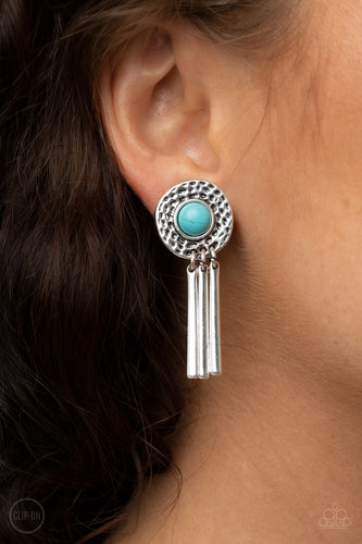 Dotted with a refreshing turquoise stone center, a hammered silver frame gives way to a fringe of shiny silver bars for a seasonal flair. Earring attaches to a standard clip-on fitting.  Sold as one pair of clip-on earrings.