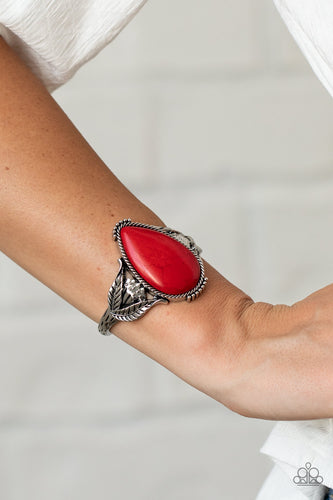 Encased in a silver rope-like frame, an oversized red teardrop stone is pressed into the center of an airy silver cuff abloom with leafy floral designs.  Sold as one individual bracelet.