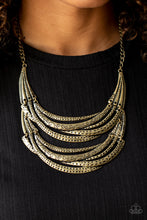 Load image into Gallery viewer, Stamped in sections of vine-like patterns, abstract hammered plates and overlapping brass bars link into an exaggerated pendant below the collar for a statement-making look. Features an adjustable clasp closure.  Sold as one individual necklace. Includes one pair of matching earrings.
