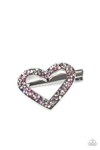 A glittery collision of hematite and purple iridescent rhinestones scatter across the front of a shiny silver heart frame for a colorful look. Features a standard hair clip on the back.  Sold as one individual hair clip.
