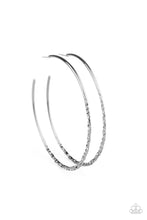 Load image into Gallery viewer, The flattened bottom of an oversized hoop has been dramatically hammered in blinding texture for a bold industrial look. Earring attaches to a standard post fitting. Hoop measures approximately 3&quot; in diameter.  Sold as one pair of hoop earrings.
